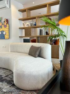 a white couch sitting in a living room at Misk Villa - Boutique Hotel & Spa in Sidi Bou Saïd