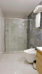 a bathroom with a shower and a toilet at Mai İnci Otel in Antalya