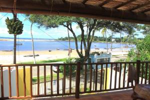 a view of the beach from the balcony of a house at Beautiful upstairs apartment - Top view in Itacaré +17 photos