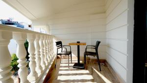 a room with a table and chairs on a balcony at Mai İnci Otel in Antalya