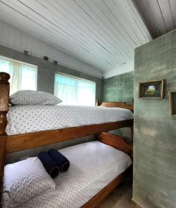 a bedroom with two bunk beds in a house at Summer beach hotel in El Charquito