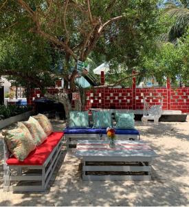 a patio with two couches and a table with pillows at Summer beach hotel in El Charquito