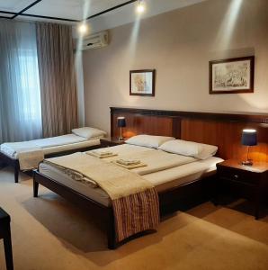 a hotel room with two beds in a room at GM Apartments Central Zone in Niš