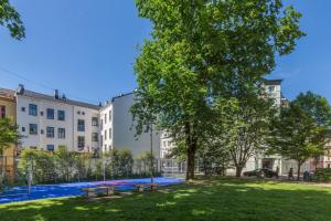 a park with benches in front of a building at **ROYAL SUITE ** MODERN ** FAST - WIFI ** SMART TV ** in Oslo