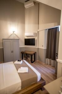 a hotel room with a bed and a desk at City Loft 3 (Stamatina's Luxury Apartments) in Alexandroupoli