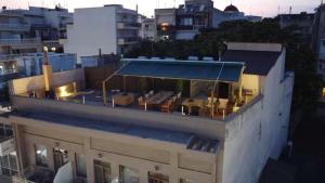 a building with a blue awning on top of it at City Loft 3 (Stamatina's Luxury Apartments) in Alexandroupoli