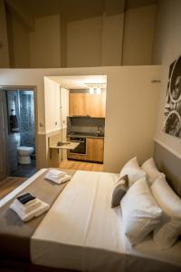 Cama grande en habitación con cocina en City Loft 3 (Stamatina's Luxury Apartments) en Alexandroupolis