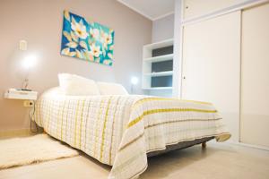 a bedroom with a bed with a blanket on it at Pueblo Nuevo in Junín