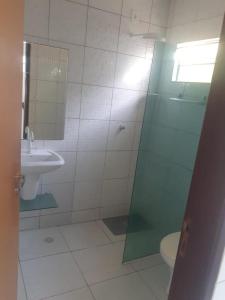 a bathroom with a shower and a toilet and a sink at Casa para Carnaval coruripe c/ piscina perto da praia in Coruripe
