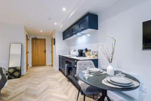 a kitchen with a table and a counter top at Deluxe Studio Apartment with Private Balcony in Stoney Middleton