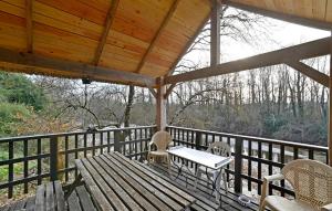 a wooden porch with a table and chairs on it at 1 Bedroom Awesome Home In Saint-Denis in Saint-Denis