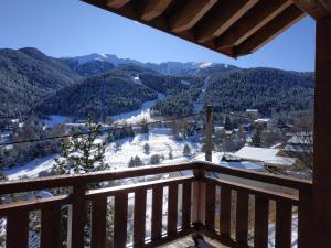 a view from the balcony of a cabin in the mountains at CHALET DE L'OURS in Saint-Pierre-dels-Forcats
