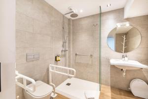 a bathroom with a shower and a sink and a toilet at General Oráa - Darya Living in Madrid