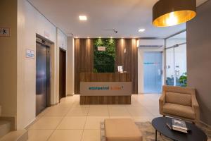 a lobby of an office building with a reception desk at Equipetrol Suites apart hotel in Santa Cruz de la Sierra
