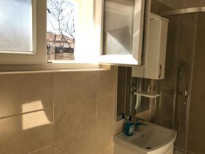 a bathroom with a toilet and a sink and a window at Summer rooms Baška 2 in Baška +37 photos