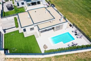 an aerial view of a house with a swimming pool at Villa Rose Nin ZadarVillas in Nin