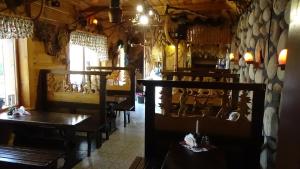 a restaurant with tables and chairs in a room at Wanta z pyszną karczmą in Bukowina Tatrzańska
