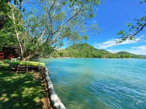 a view of a body of water with mountains in the background at Sabai Corner Bungalows - SHA Extra Plus in Ko Yao Noi