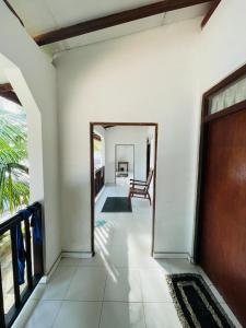 a hallway of a house with a door to a room at Rainbow Surf Beach in Koggala