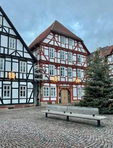 a bench sitting in front of a building at Ferienwohnungen am Markt - historischer Marktplatz im Herzen der Altstadt in Eschwege +25 photos
