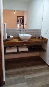 a bathroom with a sink and a large mirror at Pilgrim's Rest - Descanso del Peregrino in Chacras de Coria