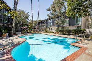 a swimming pool in a courtyard with apartment buildings at Culver City 2BR w Gym Pool nr shops LAX-330 in Los Angeles