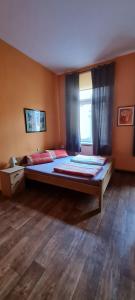 a bedroom with a large bed and a window at Pension Valeria in Plauen