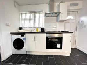 a kitchen with a stove and a dishwasher at Chic Birmingham Studio with Natural Light! in Birmingham