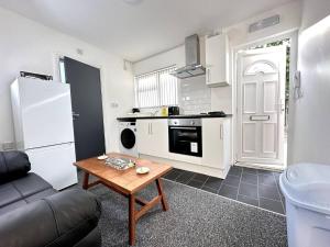 a kitchen with a couch and a table in a room at Chic Birmingham Studio with Natural Light! in Birmingham