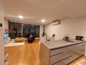 a room with a kitchen and a living room at Stylish 1 bedroom best location in Sydney