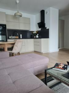 a living room with a couch and a table at Airport Apartment in Warsaw