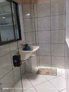 a bathroom with a sink and a shower at Pousada Brisamar Morro dos Conventos in Conventos