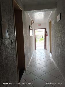 a hallway of a building with ailed floor and a door at Pousada Brisamar Morro dos Conventos in Conventos