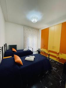 2 Betten in einem Zimmer in Orange und Blau in der Unterkunft Casa Zaccardi in Vasto