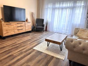 a living room with a flat screen tv and a couch at Eva's Apartment Prague in Prague