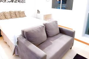 szara kanapa w pokoju z łóżkiem w obiekcie Hotel Saint Moritz Brasília - Ozped Flats w mieście Brasília