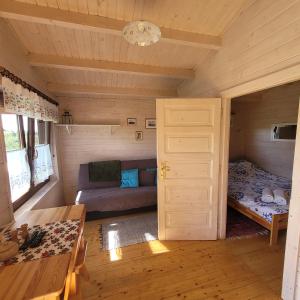 - une chambre avec un lit et un canapé dans une cabine dans l'établissement Domki pod lasem, à Rokiciny Podhalanskie