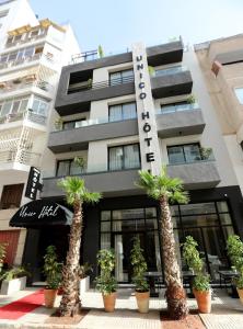 a building with palm trees in front of it at Unico Hotel & Spa Casablanca in Casablanca