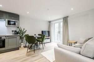 a living room with a couch and a table at No.44 - Deluxe 2-Bedroom Duplex with Balcony in Stoney Middleton