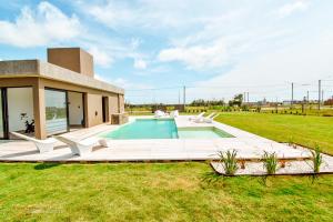 a villa with a swimming pool in a field at La Morada Almafuerte in Almafuerte