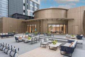 a patio with chairs and tables and a building at EVEN Hotel Zhongshan City Center, an IHG Hotel in Zhongshan