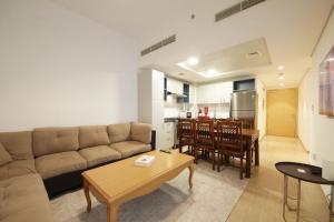 a living room with a couch and a table at Silk Valley - Furnished 2bhk Close To Metro in Dubai Marina