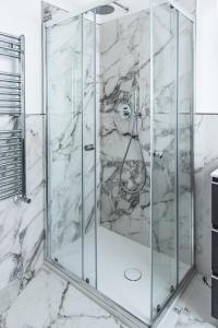 a shower with a glass door in a bathroom at Eur terrazzo vista Laghetto Modigliani in Rome