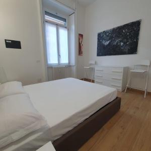 a bedroom with a large white bed and a window at BnButler - Grasselli, 8 - Comfy and Newly Renovated in Milan