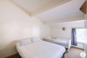 En eller flere senge i et værelse på Biscarrosse Lac- Joli duplex 6 personnes proche du lac