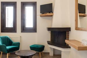 エラティ・トリカラにあるHotel Katafigioのリビングルーム(暖炉、緑の椅子付)