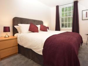 a bedroom with a large bed and a window at Home from Home - Greenwich House in Chester