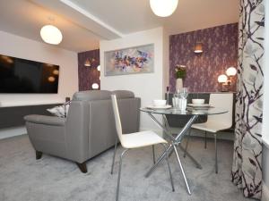 a living room with a table and a dining room at Home from Home - Greenwich House in Chester