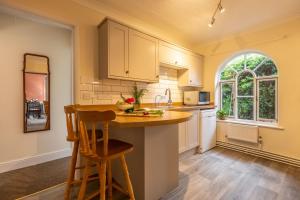 a kitchen with a counter and an arch window at The Gate House in Wymondham