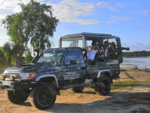 a group of people taking pictures of a truck at Kottamba Yala Stay & Safari in Tissamaharama